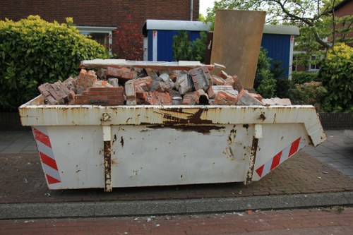 Eco-friendly disposal with recycling bins during garage clearance.